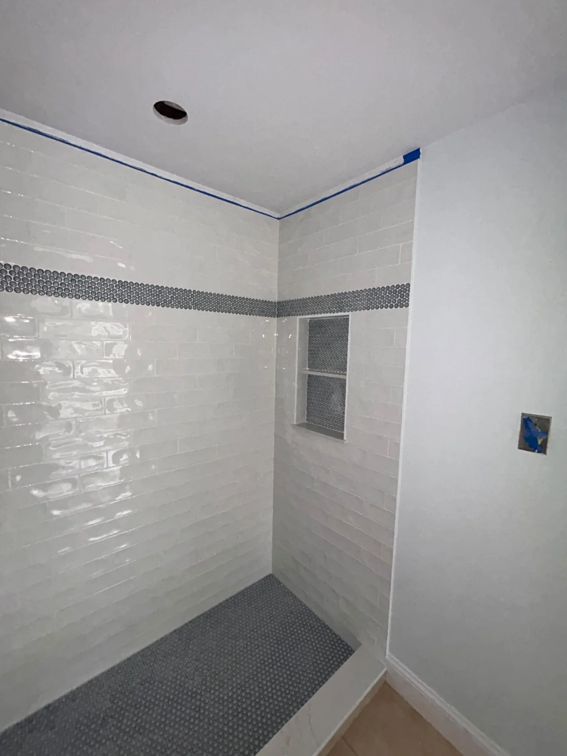Wall tile, accent band and mosaic shower base